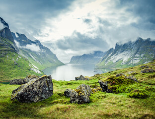 View across Reine Fjord from the hills behind the village of Kirkefjord during a rainy day on the Lofoten islands, Norway