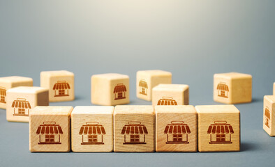 Blocks symbolizing shopping stores. Building a successful business empire. Franchise concept....