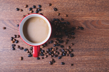 Coffee in a red coffee cup on a wooden table