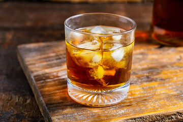 A glass of liquor on a wooden table