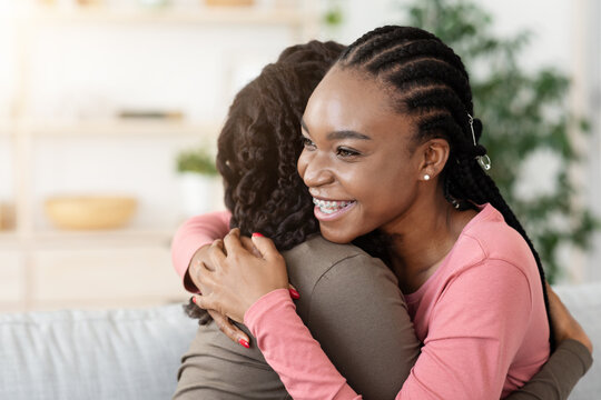 Pretty African American Girlfriends Hugging At Home