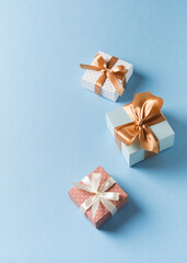 Gift boxes with ribbon flat lay on blue pastel background