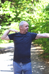 Naklejka na ściany i meble Senior man doing exercises on the street. Health care concept. Recovery from illness concept.