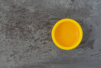 Bowl of light corn syrup on a gray background
