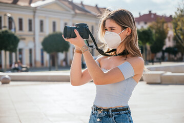 Beautiful female photographer wearing mask