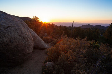Mountain sunrise beyond granite boulders