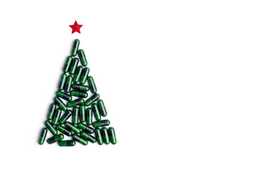 medicine pills shape of christmas tree on white background, Concept christmas and new year, medical flatlay