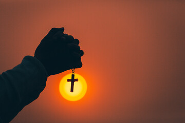 Hand holding the cross, the symbol of the blessing of Jesus, the symbol of supplication and faith,...