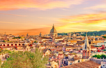 Fototapeta na wymiar Rome skyline at sunset. Rome, Italy, cityscape or landscape at sunset with a prevalent yellow orange tint kindly provided by the setting sun. Rooftops, monuments and church domes