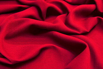 Beautiful draped wool fabric. Red fabric for decoration with decorative folds..
