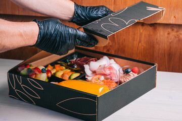 Spanish breakfast set with delivery salmon, Iberian ham, cheese orange juice in a cardboard box safe delivery