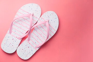  colorful sandals on pink background top down 