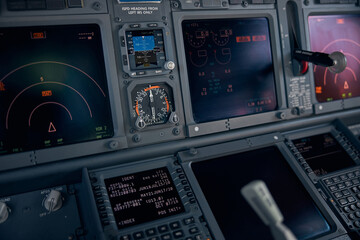Airplane cockpit with flight displays, switches and knobs