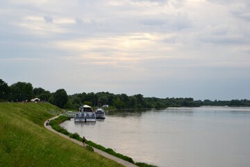 Fototapeta premium Kazimierz Dolny, Poland. Promenade on the banks of Vistula river. Popular place for tourists