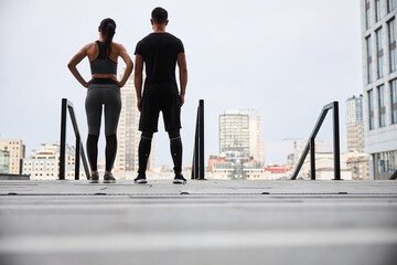 Sporty couple going training in city centre