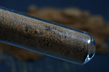 Closeup shot of dried resin granules filled on a glass tube