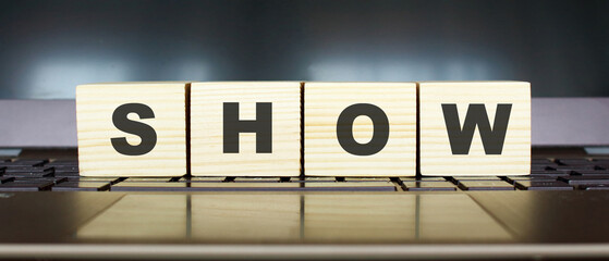 Wooden cubes with letters on a laptop keyboard.