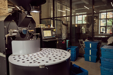 Coffee roasting machine and plastic crates at factory