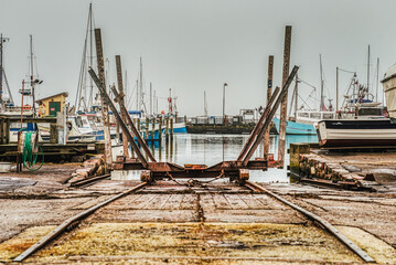 An industrial rail boat ramp or boat deployer on platform in Dragor Harbour. Rusty marine railway...