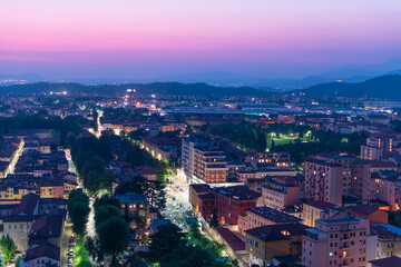 Panorama of the top view of the city in the evening just after sunset. Brescia seen from the castle at night timelapse.