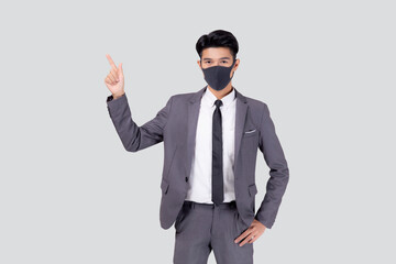 Portrait young asian businessman in suit wearing face mask for protective covid-19 isolated on white background, business man presenting and showing, quarantine for pandemic coronavirus, new normal.