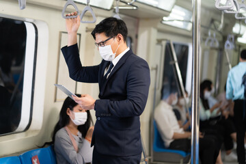 Asian young business man Passengers On public transport. Face Mask protection against virus. Covid-19, coronavirus pandemic