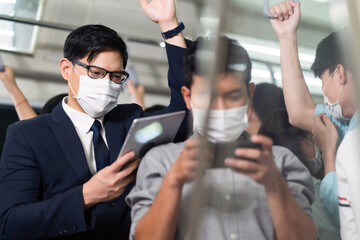 Asian young business man Passengers On public transport. Face Mask protection against virus. Covid-19, coronavirus pandemic