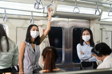 Crowd of passengers on Urban Public Transport Metro. .Asian people go to work by public transport. Face Mask protection against virus. Covid-19, coronavirus pandemic