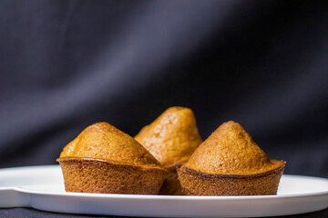 Delicious cupcakes with strawberries on a plate.