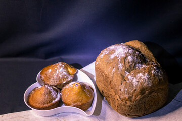 Delicious cupcakes with strawberries and bread on a plate.