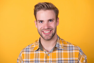 Happy unshaven young guy smile with healthy teeth yellow background, dental