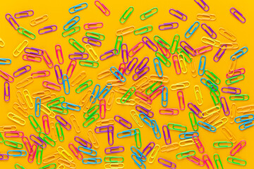 Paper color clip notebook on yellow background. Flat lay.