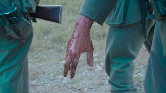 Bloody soldier hand amidst war close-up 4K. Filmed with the cooperation of Kulturno zgodovinsko Drustvo Triglav from Slovenia 