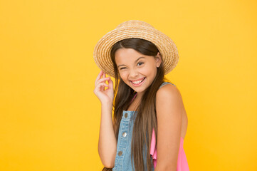 Full of joy. happy childhood. cheerful little girl wear straw hat. beach fashion for kids. small child on yellow background. holiday joy and activity. beauty. long-awaited summer vacation