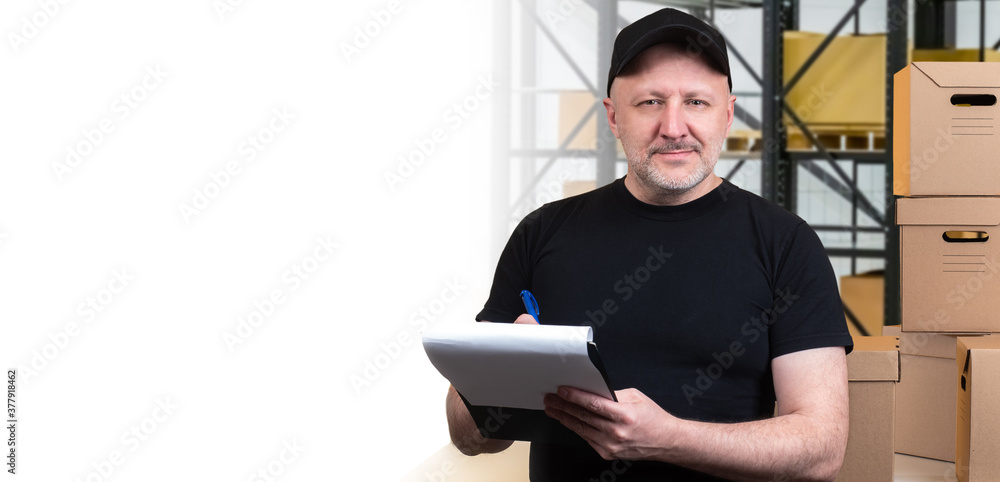 Aufkleber the concept of storage. a storekeeper with a folder in his hands looks at the camera. a friendly man