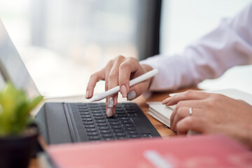 Close up. Image of woman hand working with tablet in office.