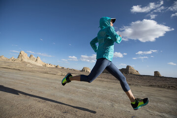 Fitness woman trail runner cross country running  on sand desert