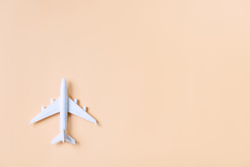 Top view of model plane, airplane on orange color background, travel concept. Flat lay , copy space