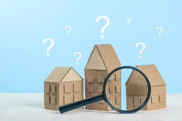 A question on a small house, a magnifying glass examines the building. Assistance in choosing and...