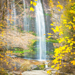 Fototapeta na wymiar Square image of Suuctu waterfall in autumn with golden leafs around and no people. Pristine nature in Turkey. Tourism in Autumn.