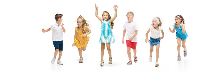 Happy children, little and emotional caucasian kids jumping and running isolated on white background. Looks happy, cheerful, sincere. Copyspace for ad. Childhood, education, happiness concept.