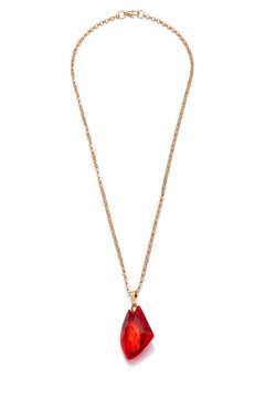 Subject shot of golden necklace with pendant made as large ruby stone. The elegant necklace with lobster clasp is isolated on the white background.