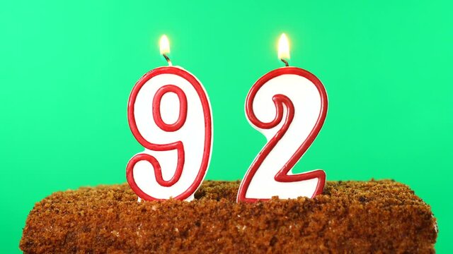 Cake with the number 92 lighted candle. Chroma key. Green Screen. Isolated