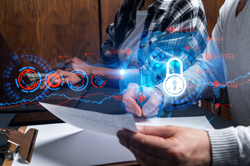 Man and woman working together on securitization of information of project. Blue icon infographic lock hologram. Concept of datum safety. Double exposure.