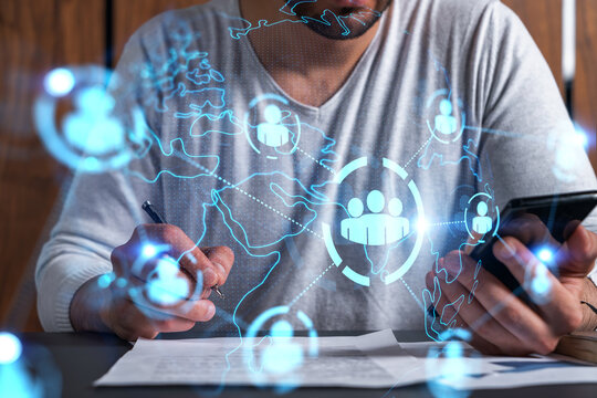 Double exposure of man signing contract with phone and social network icon hologram. Concept of international business of data and information.