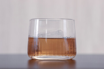 side view of bourbon on the rocks in a whiskey glass