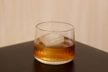 glass of whiskey (burbon) in a rocks glass with a large whiskey ice cube