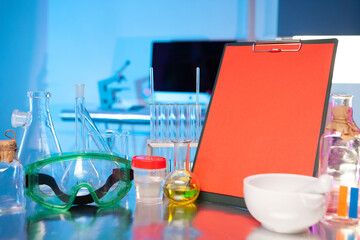 Equipping the workplace of a laboratory chemist. Everything is ready for testing new drugs. Chemical glassware, reagents and a tablet to record the results of the research.