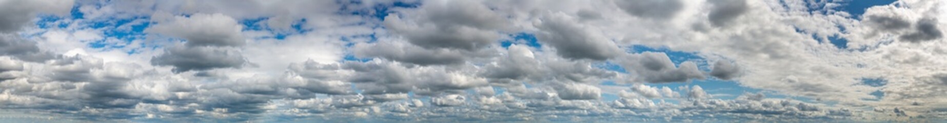 Fantastic clouds against blue sky, panorama