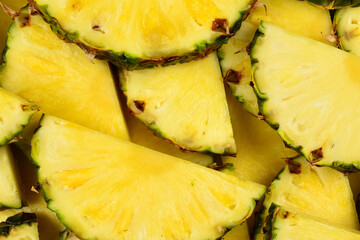Pineapple juicy yellow slices background. Top view.